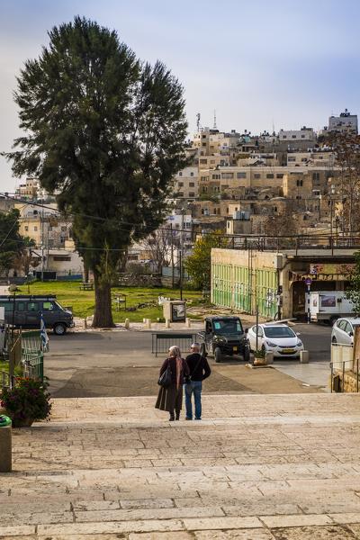 Two Jewish people walking out of the Tomb of the Patriarchs, Hebron, West Bank, Palestine