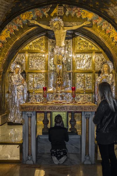 People praying in front of The Altar of the Crucifixion, Church of the Holy Sepulchre, Jerusalem, Israel, Middle East
