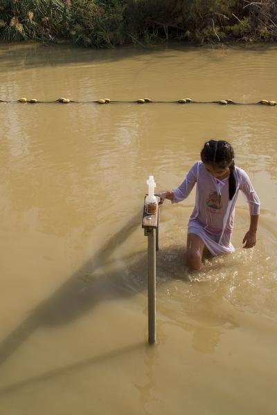 Young girl at the baptismal site Qasr el Yahud on the Jordan river, the place where Jesus Christ is being baptized, Jericho Governorate, West Bank, Palestine