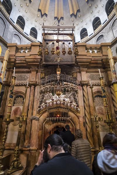 Tourists and pilgrims walk through so called Aedicule inside the Church of the Holy Sepulchre, Jerusalem, Israel, Middle East