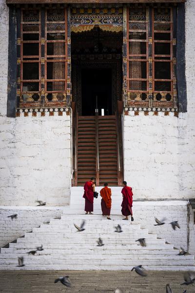 Monks at the Tashichho Dzong a Buddhist monastery and fortress on the northern edge of the city of Thimphu, Bhutan, Himalayan Country, Himalayas, Asia, Asian.