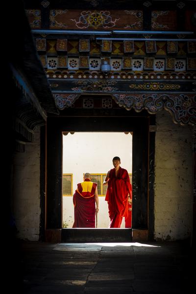 Monks at the Tashichho Dzong a Buddhist monastery and fortress on the northern edge of the city of Thimphu, Bhutan, Himalayan Country, Himalayas, Asia, Asian.