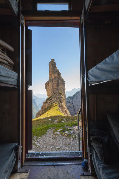 Campanile di Val Montanaia seen from the inside of the Perugian bivouac, Friulian Dolomites, Cimolais, Pordenone, Friuli Venezia Giulia, Italy