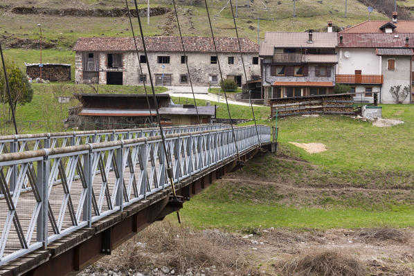 The bridge over the Cordevole river between La Agre and the village of La Muda on the background. Monti del Sole, Dolomiti Bellunesi National Park, Belluno, Veneto, Italy