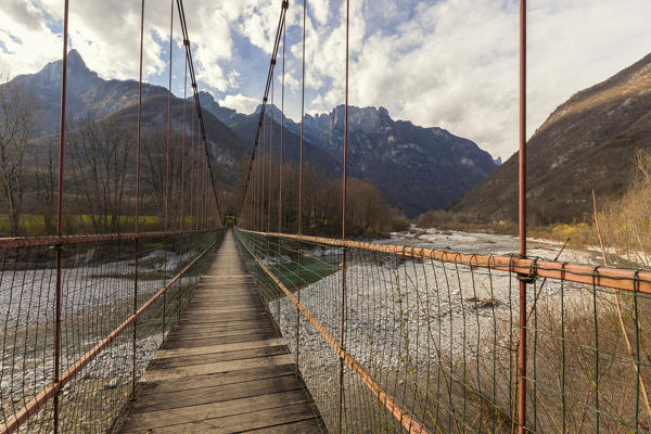 The bridge over the Cordevole river between Peron and San Gottardo. On the backgroud Monti del Sole southern area. National Park of Dolomiti Bellunesi, Belluno, Dolomites 