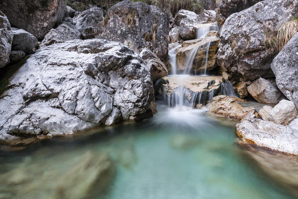 Small waterfalls of turquoise water in val Salet, Monti del Sole, National park Belluno Dolomites, Italy