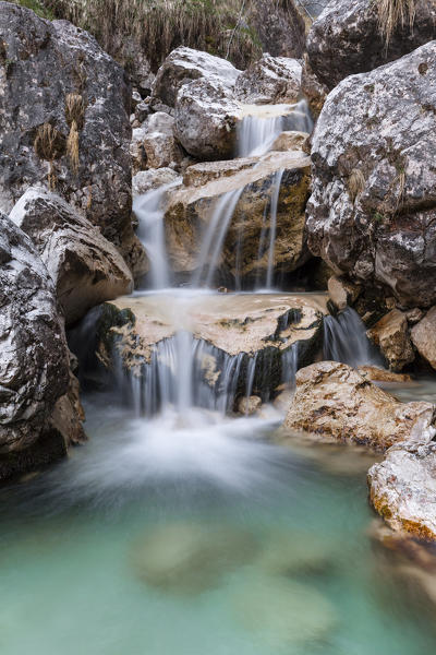 Small waterfalls of turquoise water in val Salet, Monti del Sole, National park Belluno Dolomites, Italy