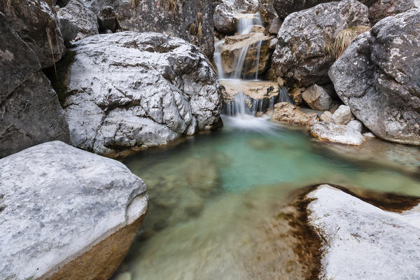 Small waterfalls of turquoise water in val Salet, Monti del Sole, National park Belluno Dolomites, Italy