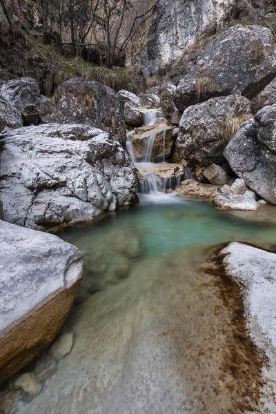 Small waterfalls of turquoise water in val Salet, Monti del Sole, National park Belluno Dolomites, Italy