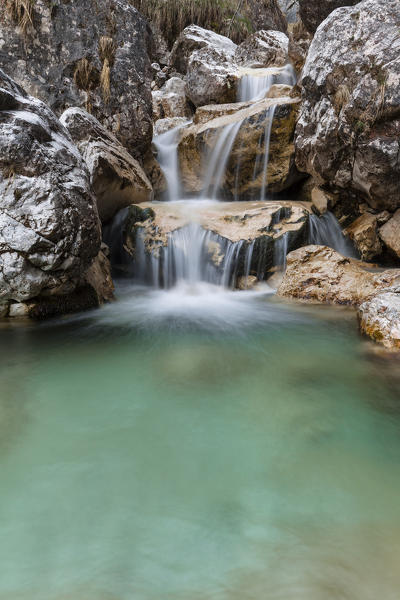 Small waterfalls of turquoise water in val Salet, Monti del Sole, National park Belluno Dolomites, Italy