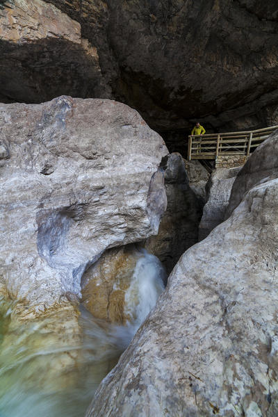 Dolomites, Belluno, Veneto, Italy. An hiker looking from above of the Soffia waterfall.