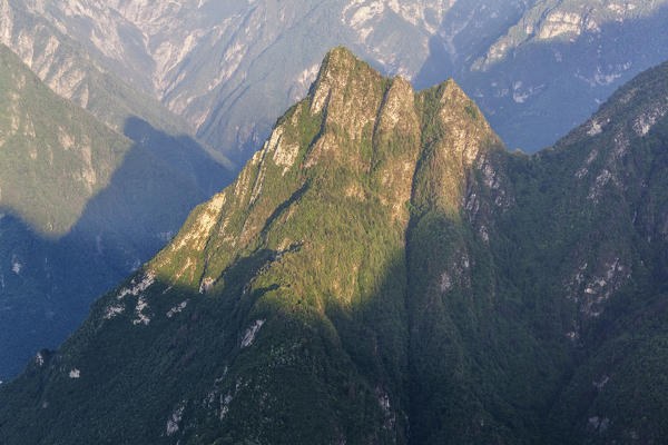 Sospirolo, Veneto, Italy, Dolomiti Bellunesi National Park. The sharp pyramid of Spiz Vedana illuminated by the morning sun.