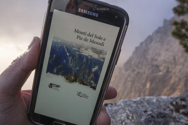 europe, North Italy, Veneto, Belluno, Monti del Sole, Dolomites.  The monograph dedicated to the Mountains of the Sun loaded on a smartphone and ready for use at any time