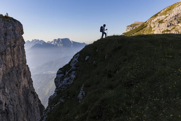 Hiker in silhouette near fork Besausega, Dolomites, Pale di San Lucano, Agordino, Belluno, Veneto, Italy, Europe