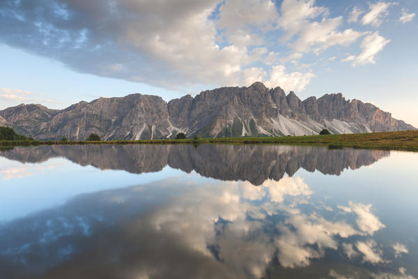 Europe, Italy, South Tyrol, Bolzano. Odle di Eores (Aferer Geisler) reflected in the Wackerer lake at sunset, Dolomites