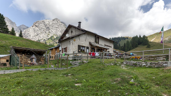 Europe, Italy, Veneto, Belluno. The Boz alpine hut, on the lawns of the Neva in the Cimonega group, Cesiomaggiore, Dolomites, Belluno Dolomiti National Park