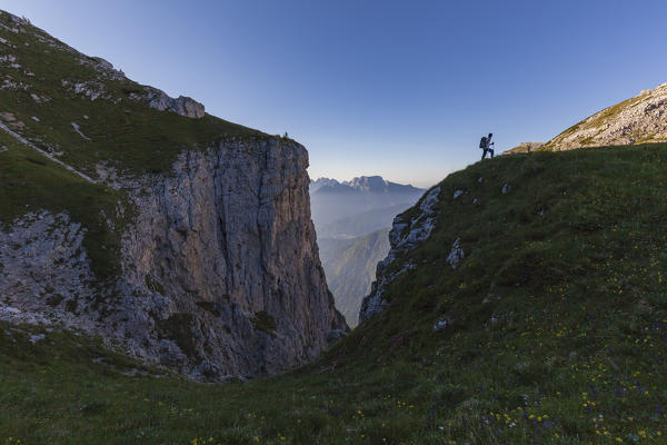 Hiker in silhouette near fork Besausega, Dolomites, Pale di San Lucano, Agordino, Belluno, Veneto, Italy, Europe