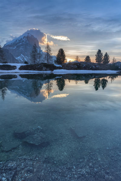 Europe, Italy, Veneto, Falzarego, Belluno. Morning view of the Tofana di Rozes reflected in the calm water of the Limedes lake, Dolomites