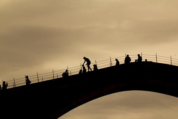 Eastern Europe, Bosnia and Herzegovina. 
Tourists on the Stari Most (the Old Bridge) awaiting the famous jump in the Naretva river