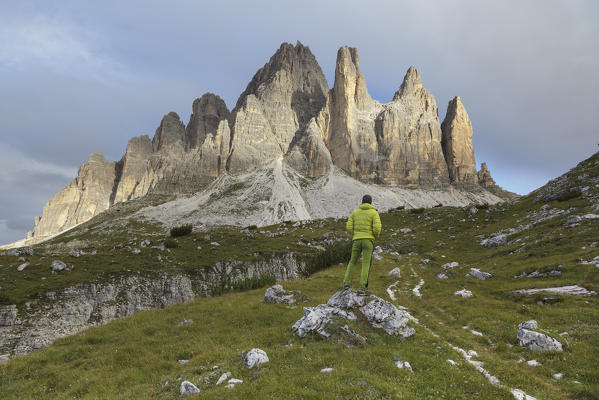 Europe, Italy, Veneto, Belluno. An hiker looking the  Tre Cime di Lavaredo south side, Dolomites