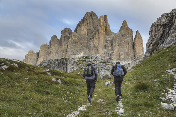 Europe, Italy, Veneto, Belluno. Hikers on a path near Tre Cime di Lavaredo south side, Dolomites