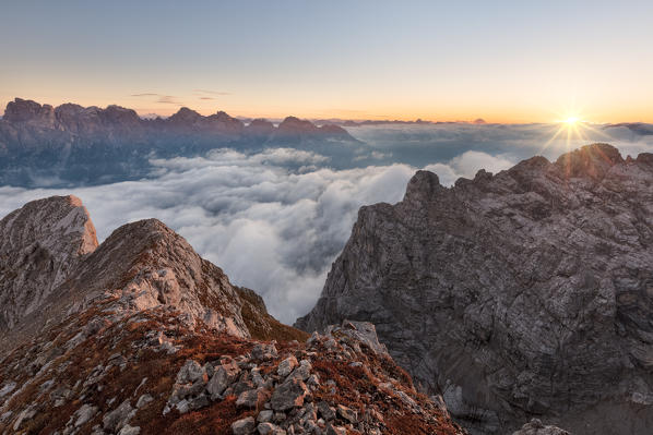 Europe, Italy, Veneto, Cadore, Auronzo. Sunrise with sea of clouds from Camosci peak, Marmarole, Sexten Dolomites in the background