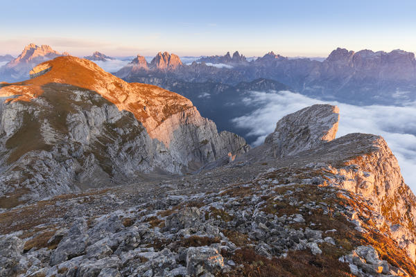 Europe, Italy, Veneto, Cadore, Auronzo. Sunrise with sea of clouds from Camosci peak, Marmarole. Croda Alta di Somprade in the background and the Sexten Dolomites backdrop