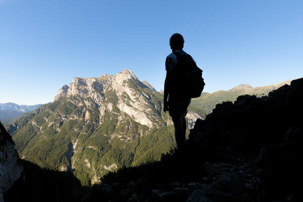 Europe, Italy, Veneto, Agordino, Dolomites, mountaineer silhouette towards the Pale of San Lucano