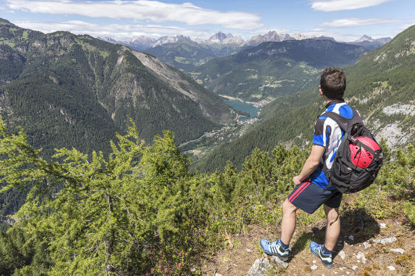 Europe, Italy, Veneto, San Tomaso Agordino, Dolomites, hiker looking Alleghe and the lake from the Col Mandro lookout