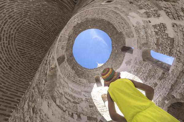 Yong girl inside the roman vestibule of Diocletian Palace in Split, Dalmatia, Croatia (MR)