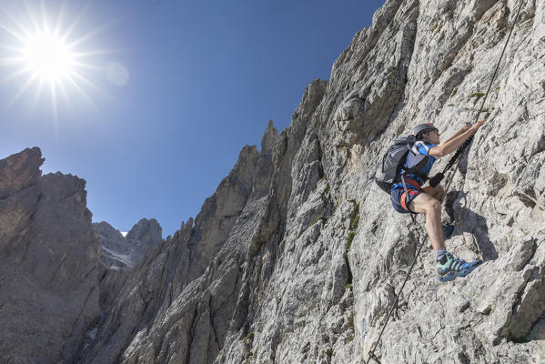Climber on the via ferrata Roghel, Popera group, Sexten Dolomites, Comelico Superiore, Belluno, Veneto, Italy