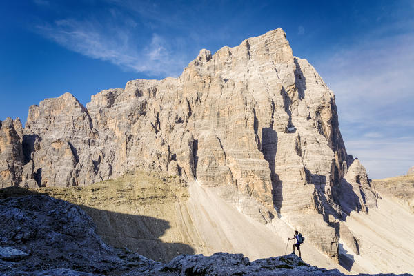 South Tyrol, Sexten, Bolzano. Hiker in silhouette in front of the north east wall of Croda dei Toni, Sexten Dolomites (MR)