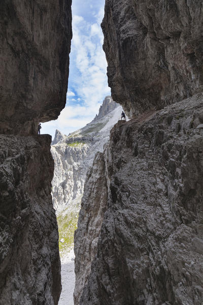 Italy, South Tyrol, Sexten, Hochpustertal, Bolzano. Hiker in silhouette on the Alpinisteig or Strada degli Alpini via ferrata, Sexten Dolomites