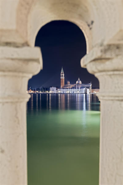 glimpse of the island of San Giorgio Maggiore framed between the columns of a bridge, Venice, Veneto, Italy
