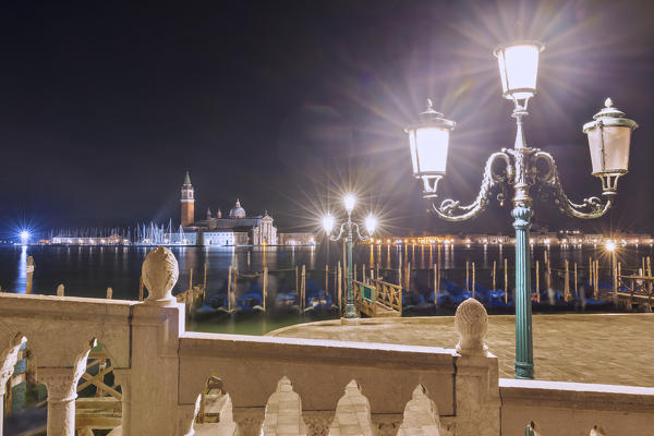 Gondolas dock, lamp post and San Giorgio Maggiore Church, Venice, Veneto, Italy