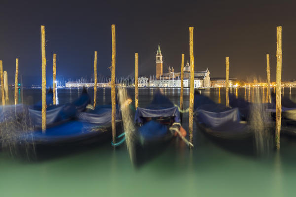 Venetian gondola moored on Grand Canal and San Giorgio Maggiore Church in background, Venice, Veneto, Italy