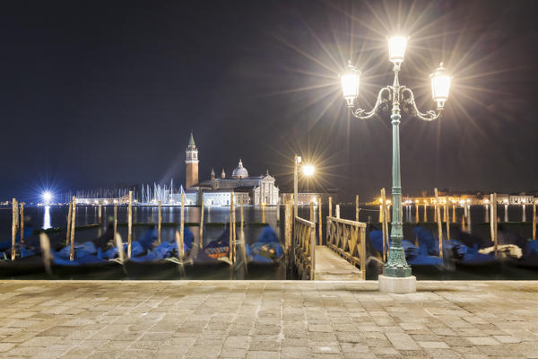 Gondolas dock, lamp post and San Giorgio Maggiore Church, Venice, Veneto, Italy