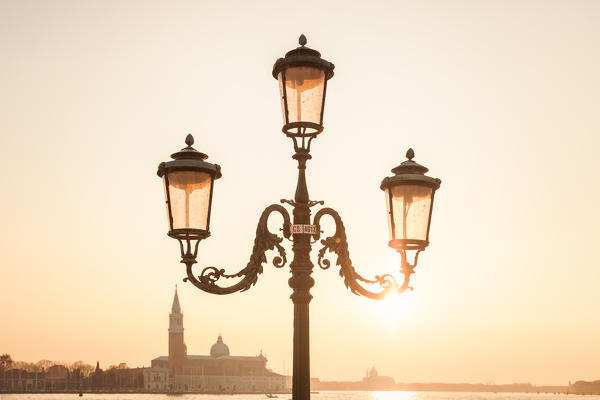 characteristic venetian lamp post in Riva degli Schiavoni, in the background the island of San Giorgio maggiore, Venice, Veneto, Italy