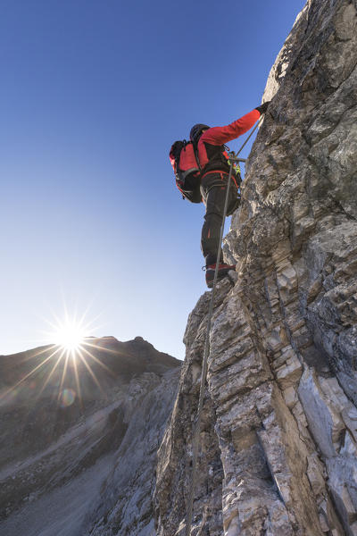 Mountaineer along the via ferrata on the north side of mount Gr. Kinigat, Kartitsch, East Tyrol, Austria, Europe