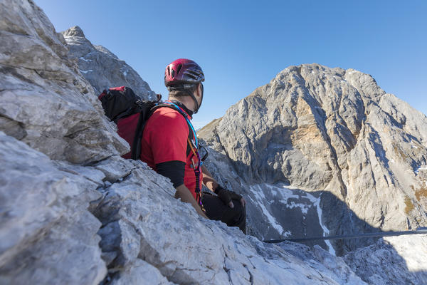 Mountaineer along the via ferrata on the north side of mount Gr. Kinigat, Kartitsch, East Tyrol, Austria, Europe