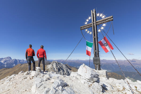 the peak of the mount cavallino (Gr. Kinigat) on the border between Italy and Austria with the cross of Europe and the flags of the two states, Kartitsch, Carnic alps, Europe