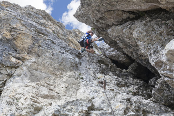 Europe, Italy, Veneto, Agordino, mountain climber on the via ferrata Stella Alpina at mount Agner, Pale di San Martino, Dolomites