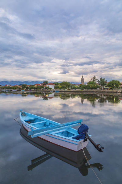 small fishing boat anchored in the bay in front of Nin, in the background the mountains of the Velebit, Nin, Zadar county, Dalmatia, Croatia