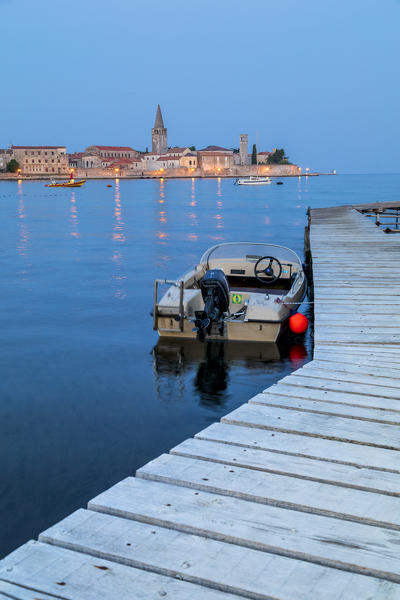 Porec, old town coast view with the Euphrasian basilica, motorboat docked, Istria, Croatia