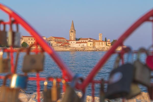 Porec, old town coast view with the Euphrasian basilica, Unesco world heritage site, in the foreground an installation with padlocks, Istria, Croatia