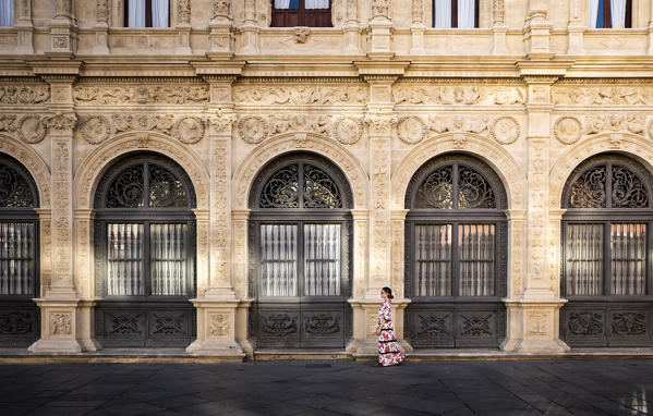 A girl in a typical spanish dress walking in Seville, Andalucia, Spain