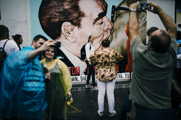 People taking pictures in front of East Side Gallery, Kreuzberg, Berlin, Germany