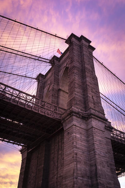 Close view of Brooklyn bridge during a colorful sunset. Manhattan, New York City, USA