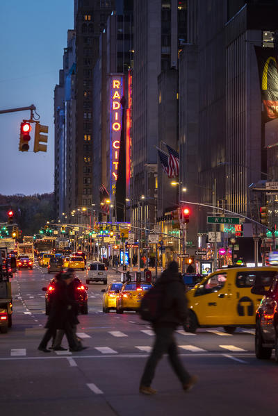 Paople and Taxi on Manhattan street near the Radio City Hall. Manhattan, New York, USA
