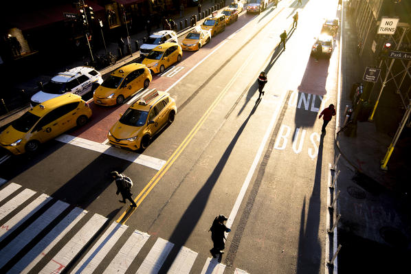 Sunrise in Manhattan with people crossing the road near the Grand Central Station. MAnhattan, New York, USA